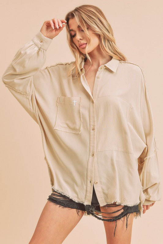 CHRISTIAN FASHION CLOTHING BRAND - ATALIE THE LORD IS EXALTED. The Phoebe Top is an essential button down. This forever classic style is slouchy, has an oversized fit and raw edge detailing that adds the perfect shape to any look. Our signature cross can be found on the right front pocket. 100% Cotton Imported